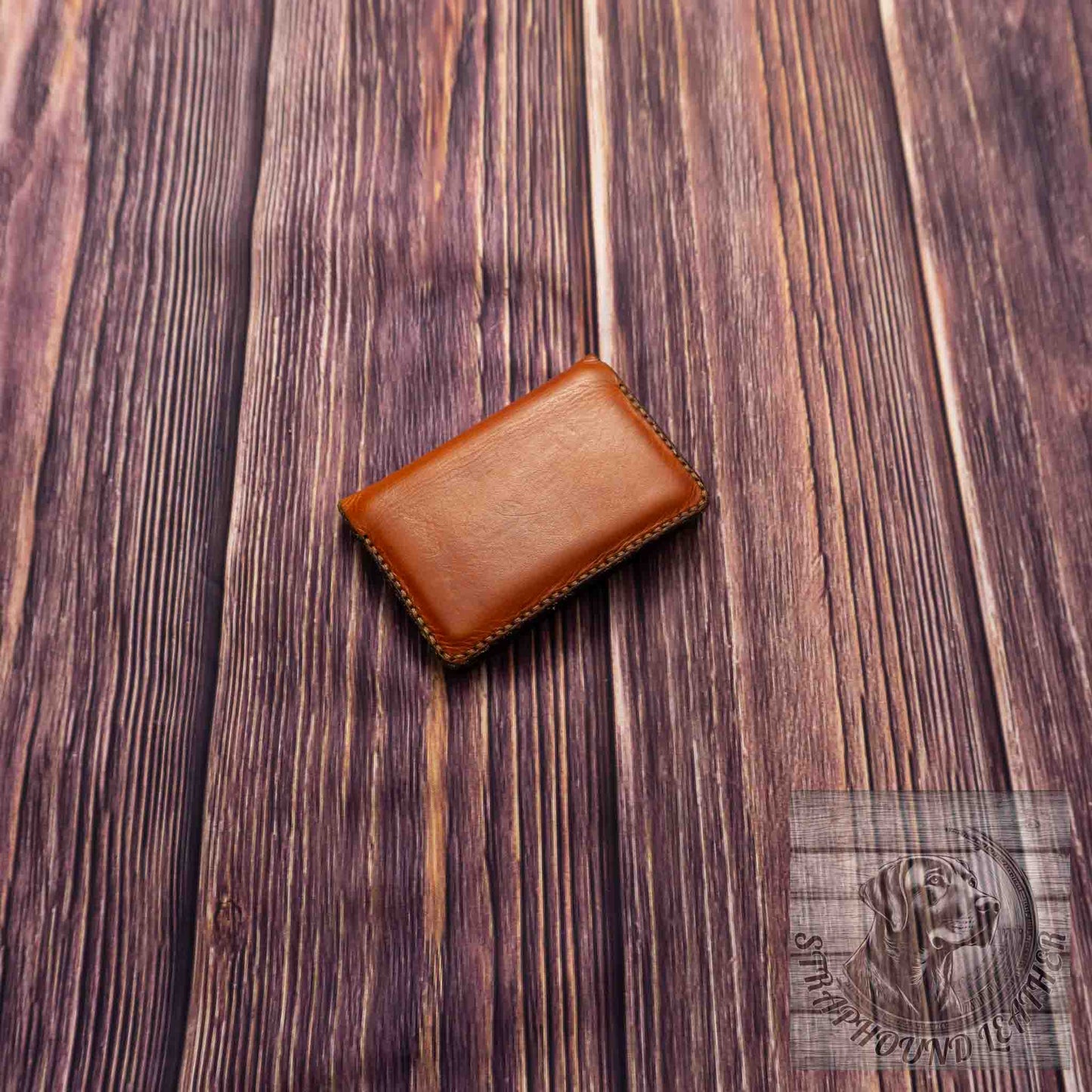 photo of wood grain background with a walnut leather wallet
