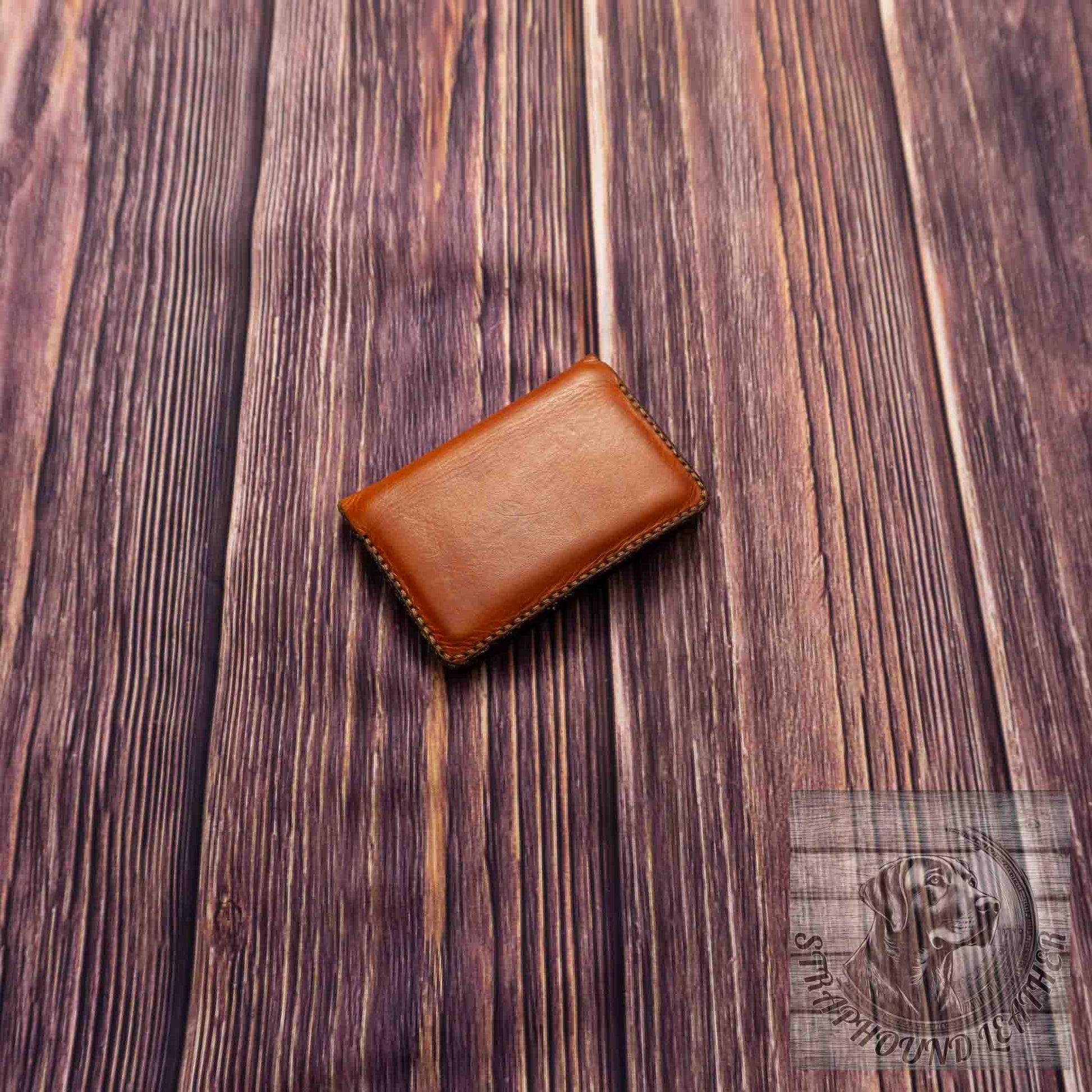 photo of wood grain background with a walnut leather wallet