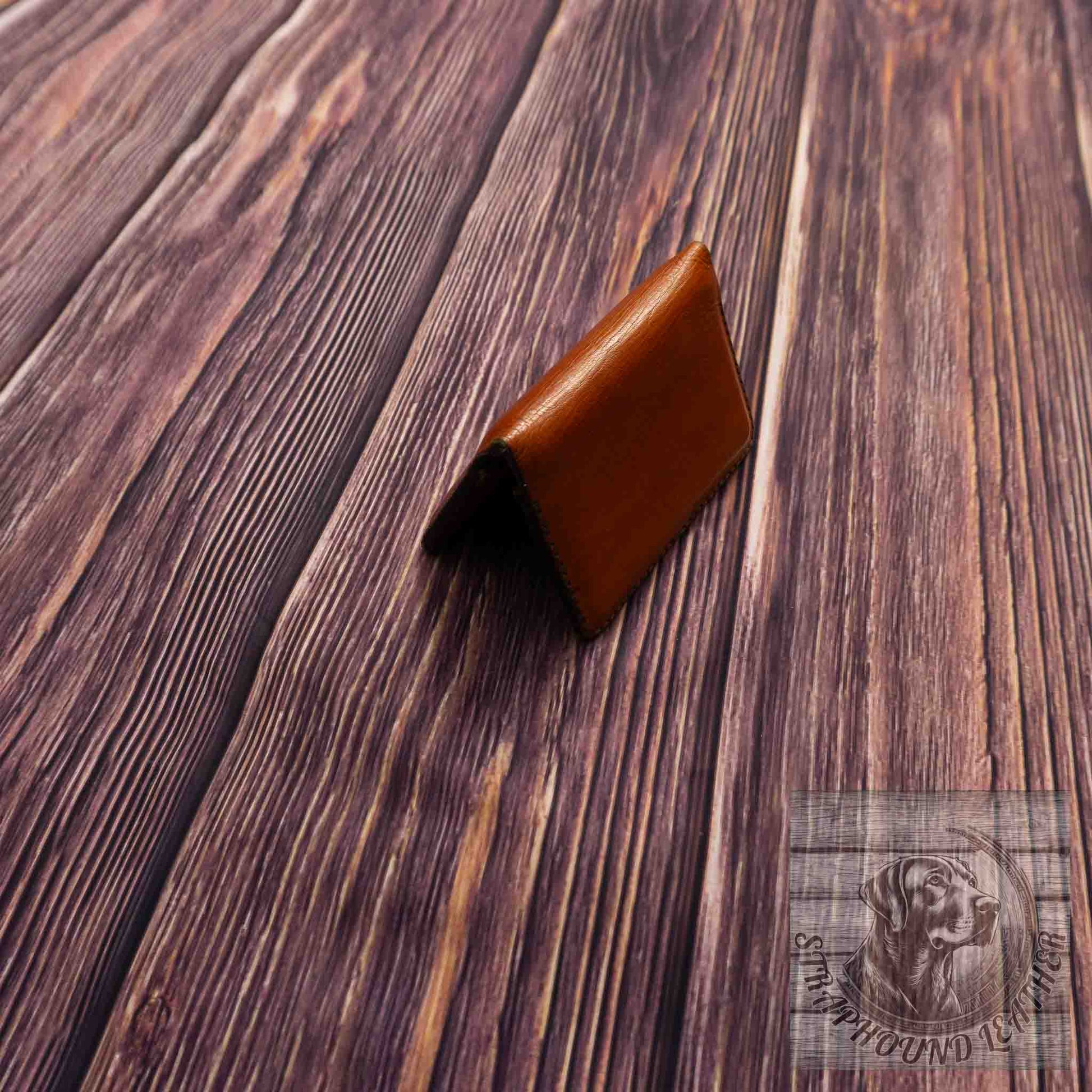 photo of wood grain background with a walnut leather wallet