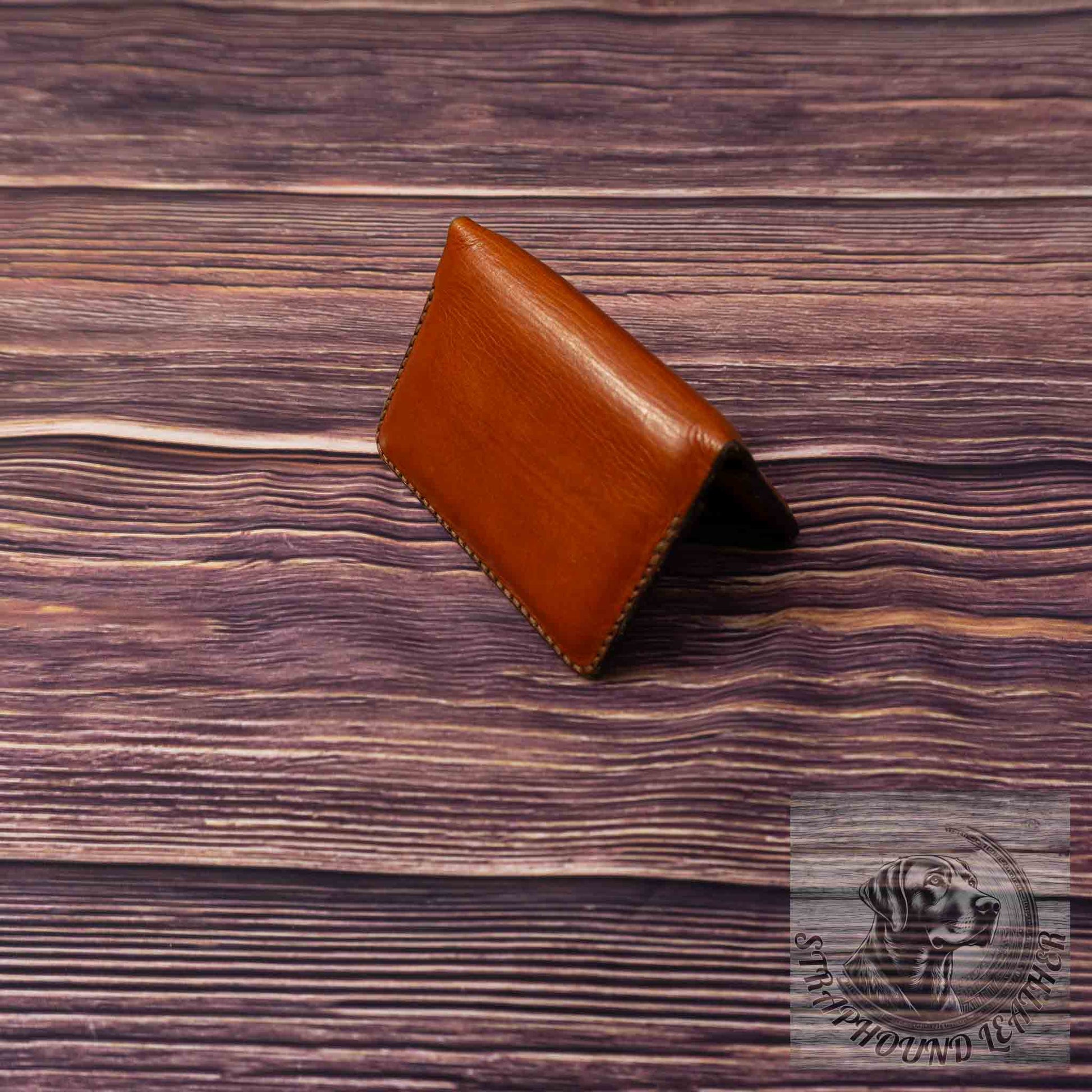 photo of wood grain background with a walnut leather wallet